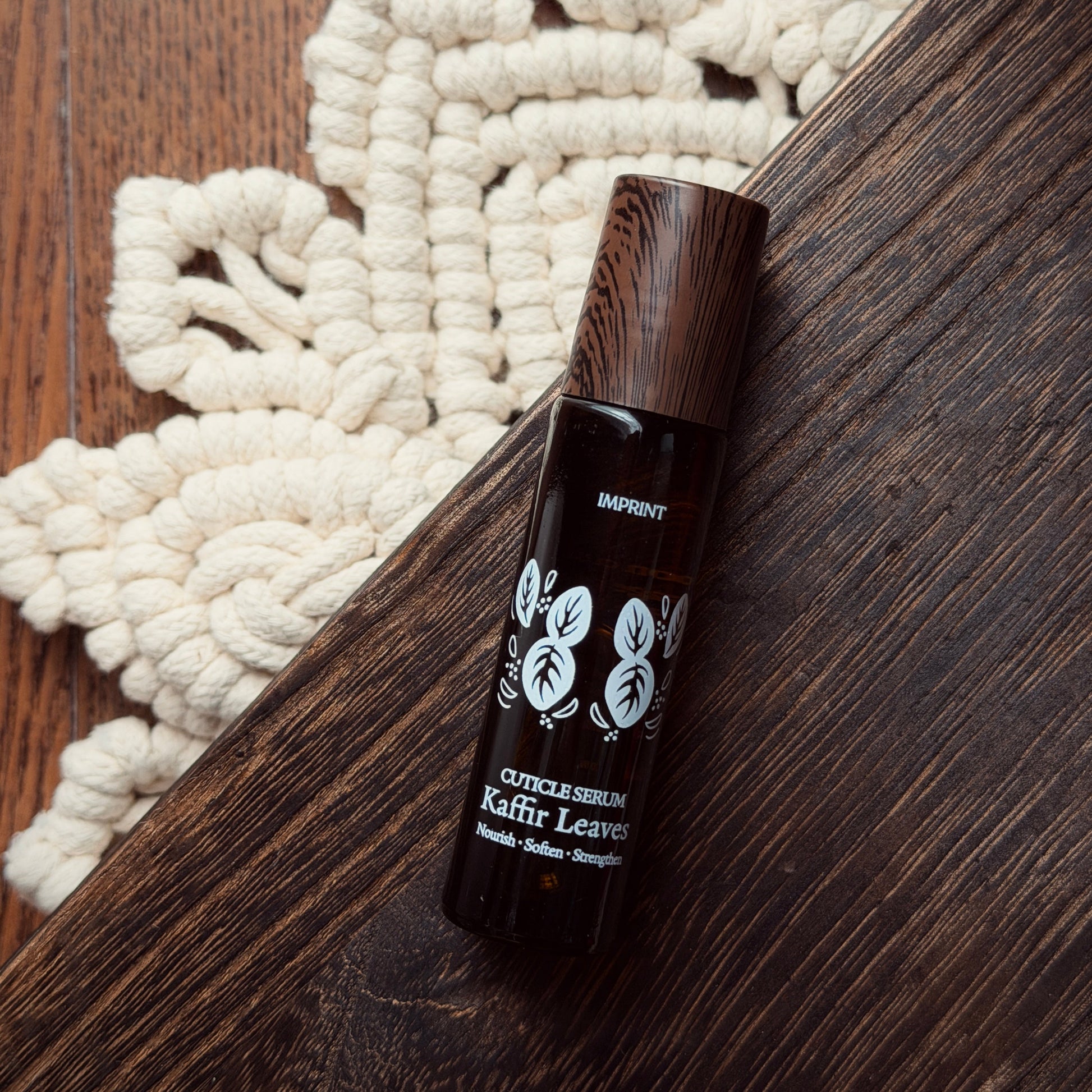 Dark brown bottle with white text on a wooden surface