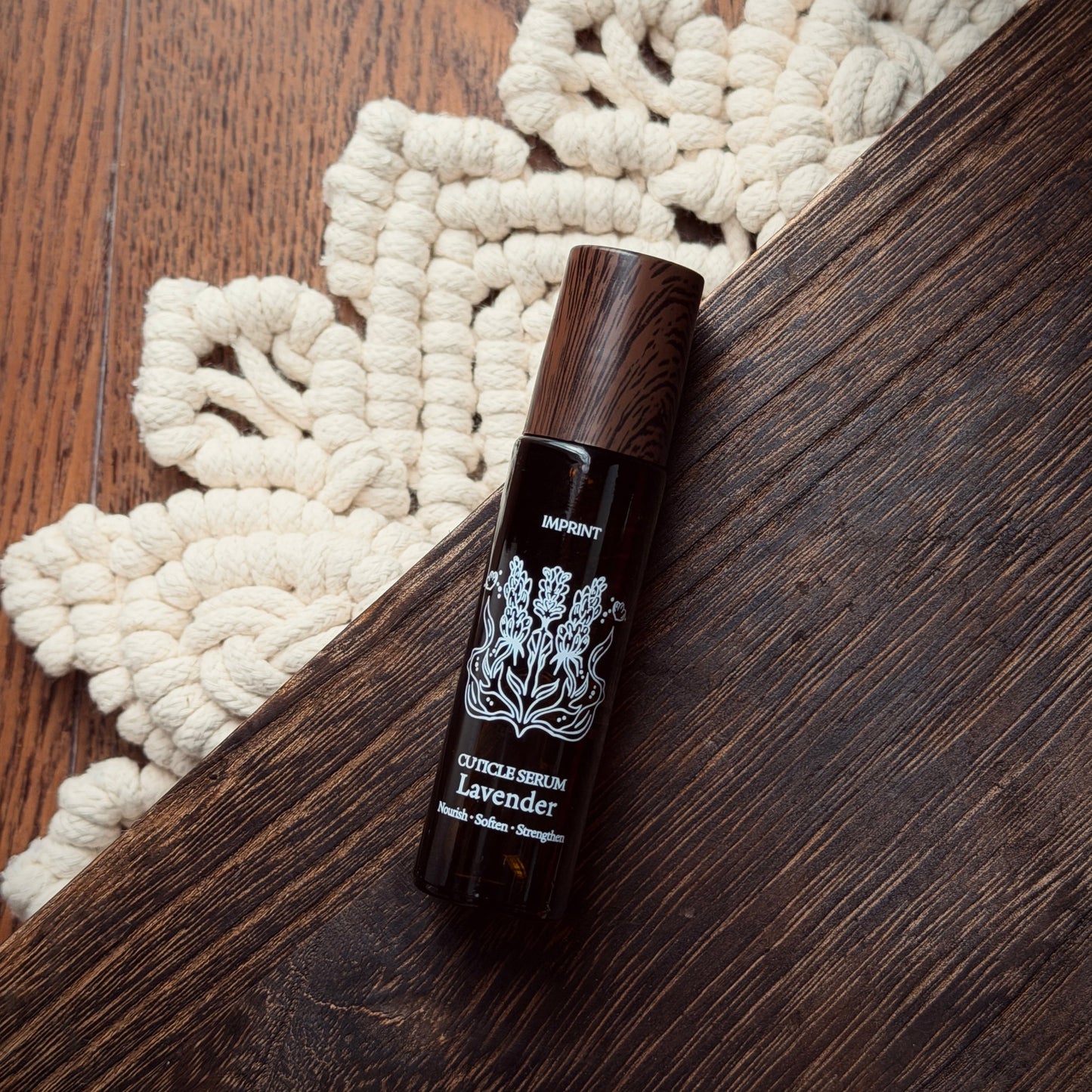 Dark brown bottle with white label on a wooden surface